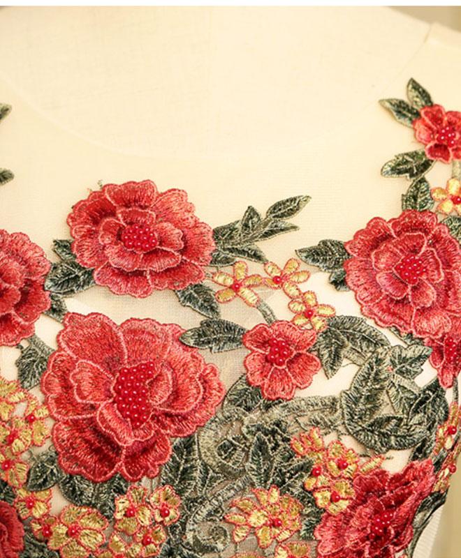 Close-up of embroidery detail on the red satin dress.