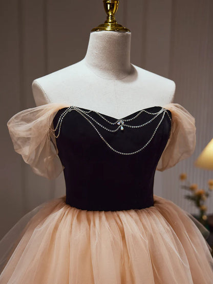 Back view of the champagne and black sweetheart homecoming dress on a model.