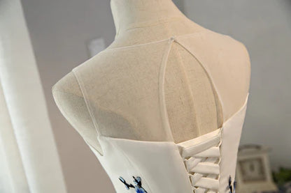 Close-up of the white tulle fabric and layered skirt of the dress.