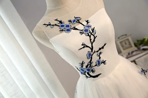 Detail of the white tulle dress showing its delicate texture.
