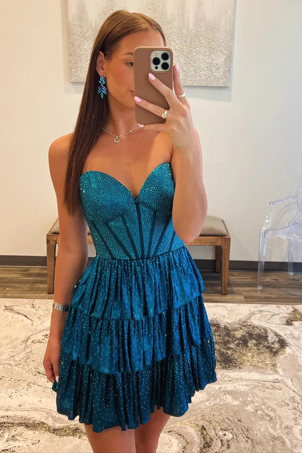 Peacock blue strapless A-line tiered homecoming dress with sweetheart neckline and beading.