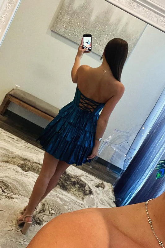 Back view of the peacock blue strapless A-line tiered homecoming dress.