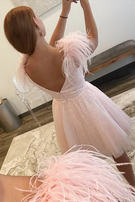 Side view of the pink A-line V-neck dress, highlighting the feathered shoulder embellishments.