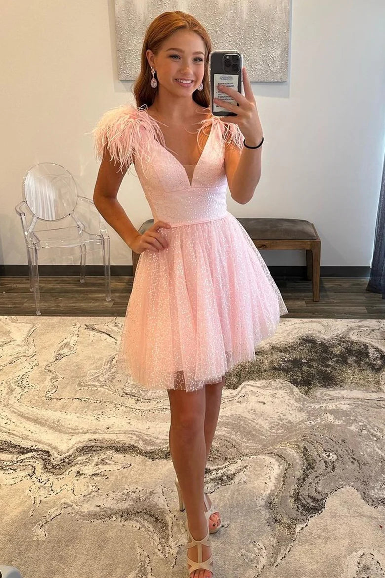 Back view of the short pink A-line homecoming dress, showing the glittery tulle skirt.