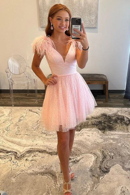 Back view of the short pink A-line homecoming dress, showing the glittery tulle skirt.