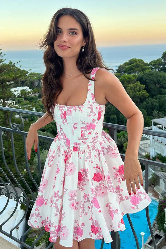 Model wearing a pink A-line floral short homecoming dress.