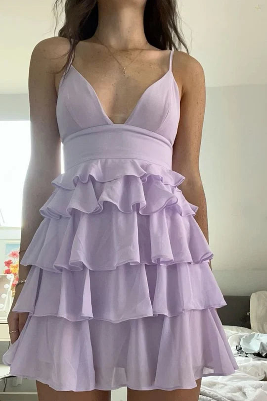Full view of a lilac short homecoming dress with spaghetti straps and a V-neckline.