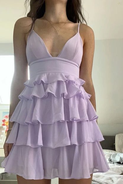 Full view of a lilac short homecoming dress with spaghetti straps and a V-neckline.