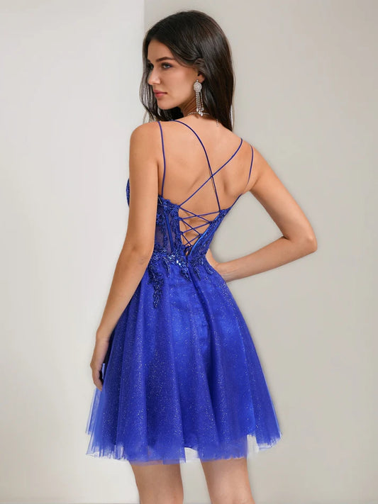 Side view of a short A-line tulle dress featuring a V-neck and delicate strap details.