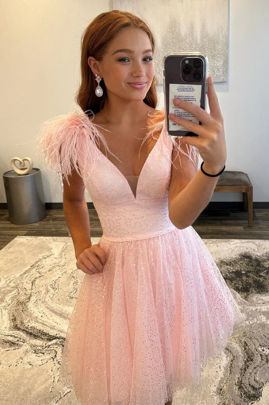 Model wearing an A-line deep V-neck tulle homecoming dress with feathers.