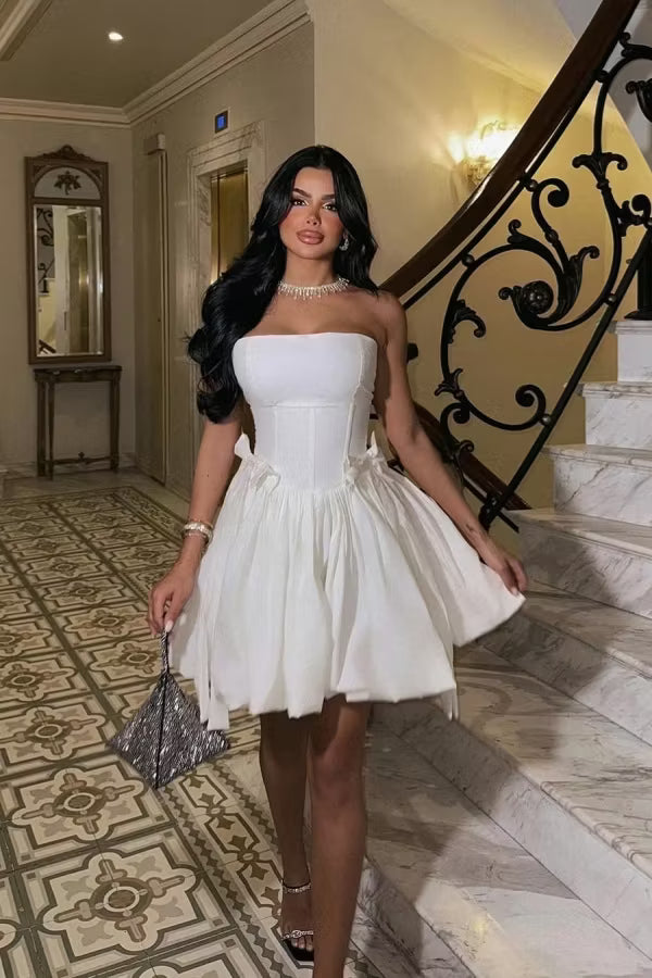 Model wearing an elegant white strapless corset bubble mini homecoming dress.