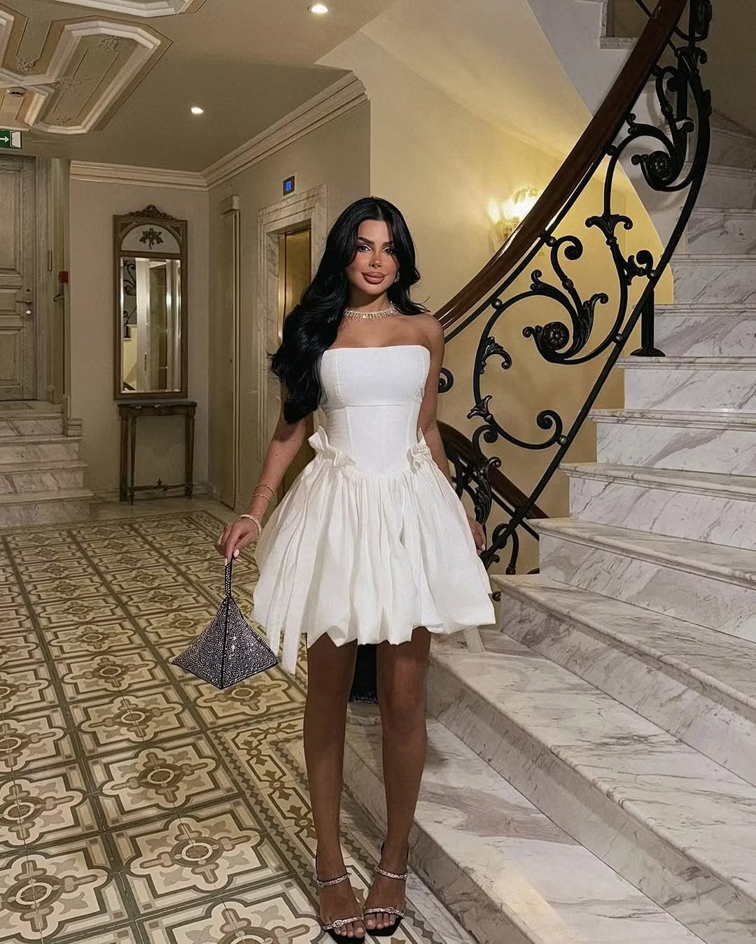 Close-up of the white strapless corset bodice and bubble mini skirt.