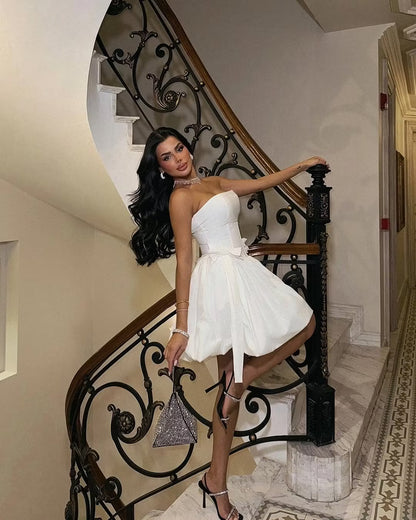Back view of the white strapless corset bubble mini dress.