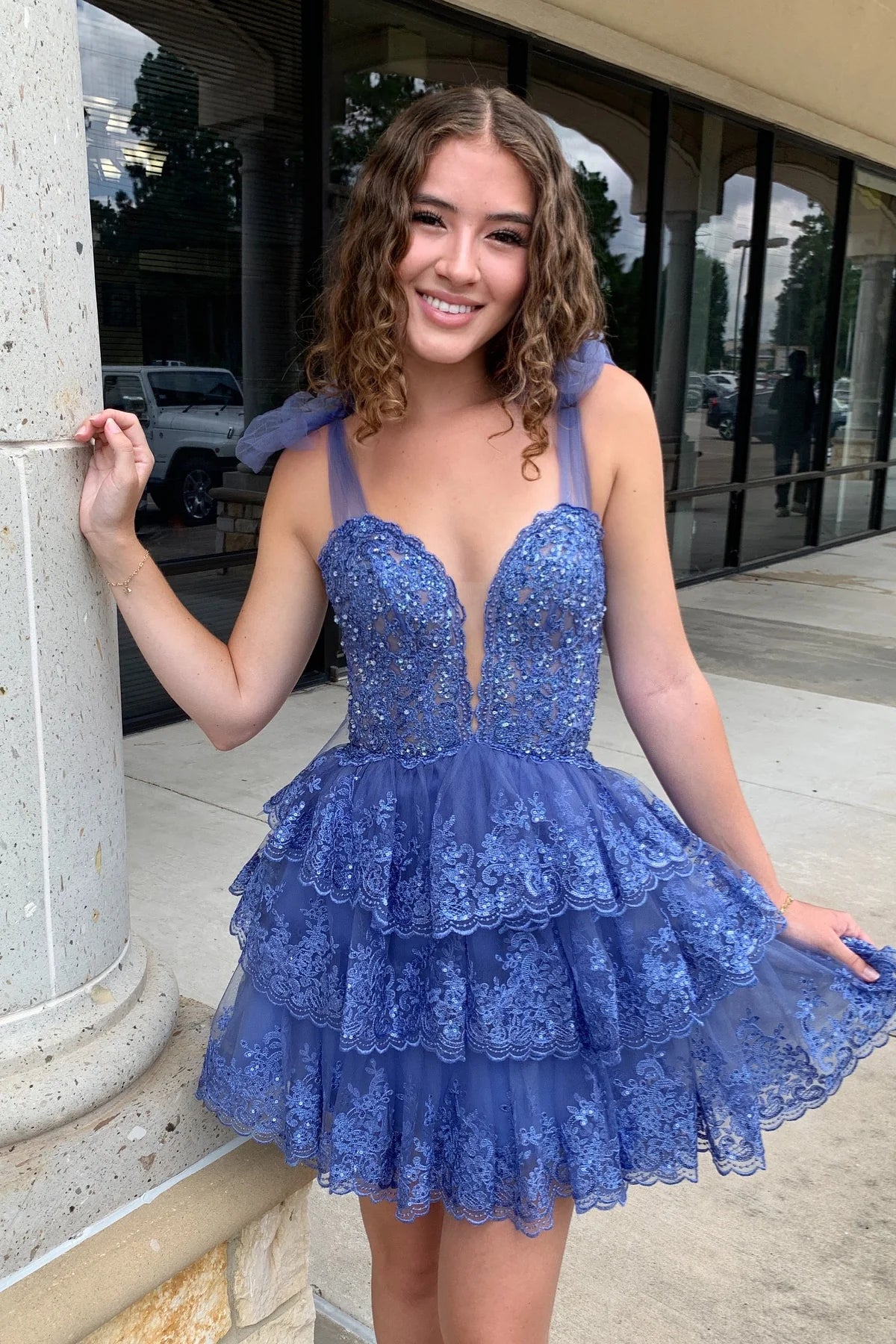 Full length view of a model wearing the light blue short homecoming dress.