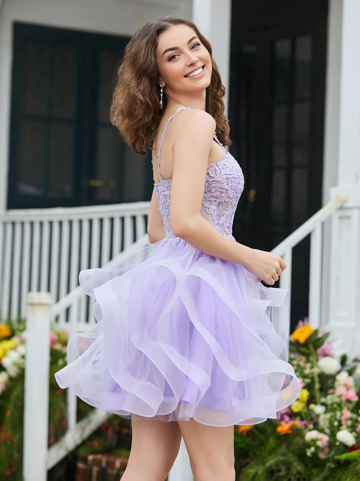Lilac short tulle homecoming dress with appliqued corset top and deep V-neck, back view.