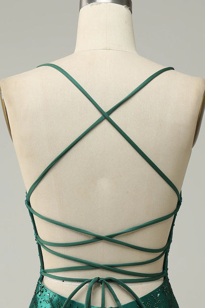 Close-up of the dark green beaded fabric on the bodycon dress.