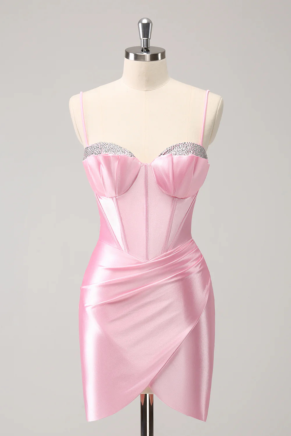 Model wearing a pink beaded bodycon homecoming dress with spaghetti straps.