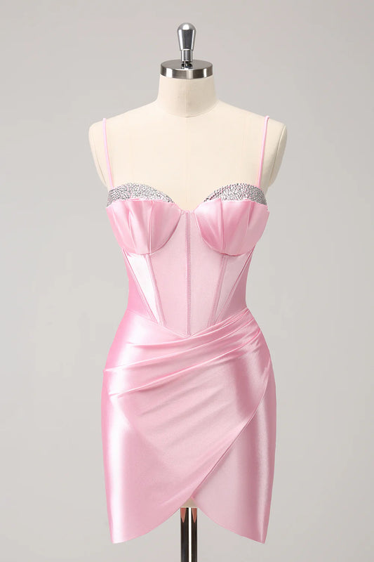 Model wearing a pink beaded bodycon homecoming dress with spaghetti straps.