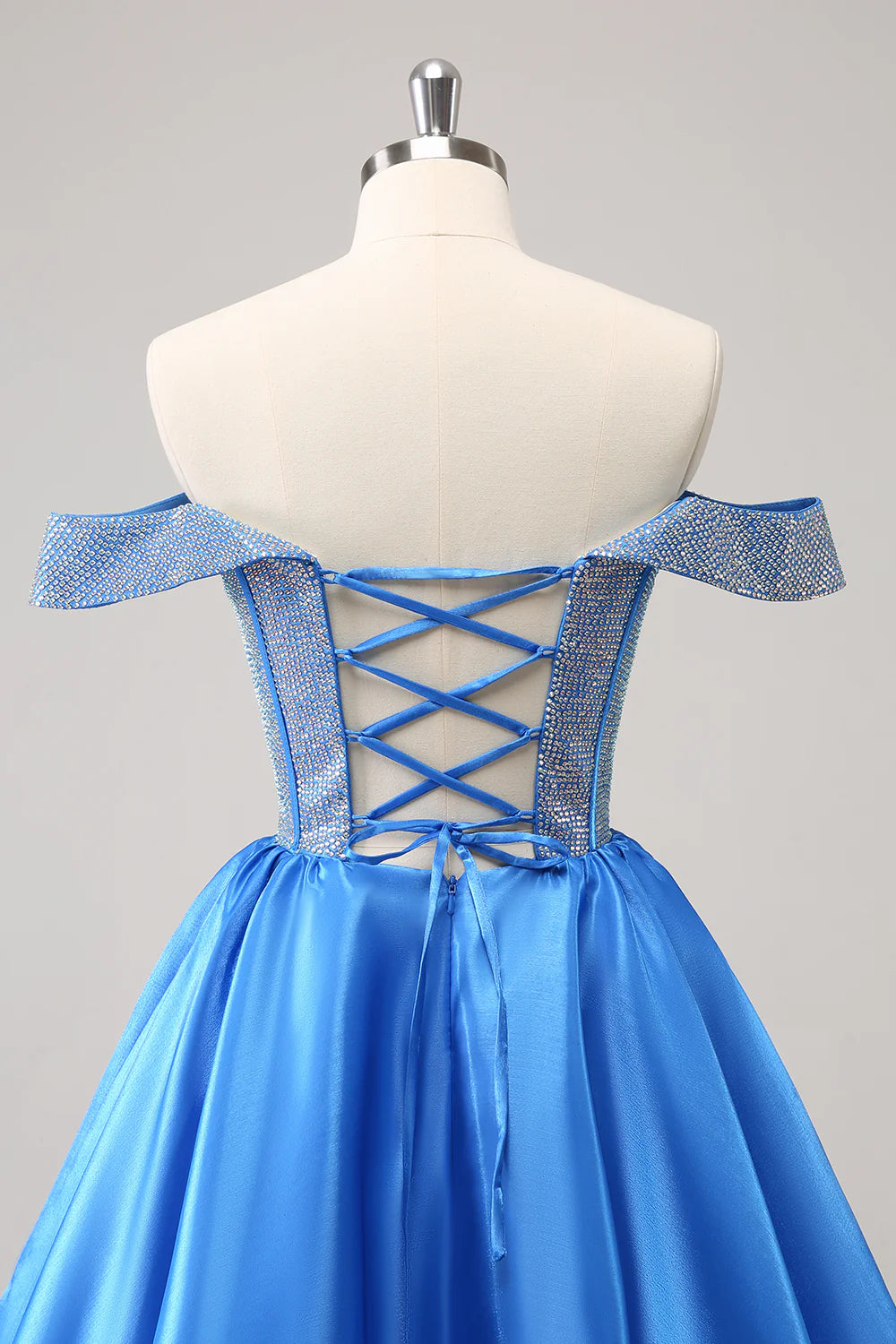 Full length view of a blue A-line off-shoulder beaded satin gown.