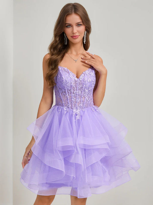 Front view of an elegant short beaded tulle ball gown homecoming dress with spaghetti straps.