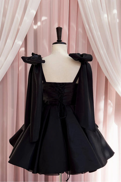 Model wearing Koutun Black Bow Tie Pleated A-line Short Dress, side view.