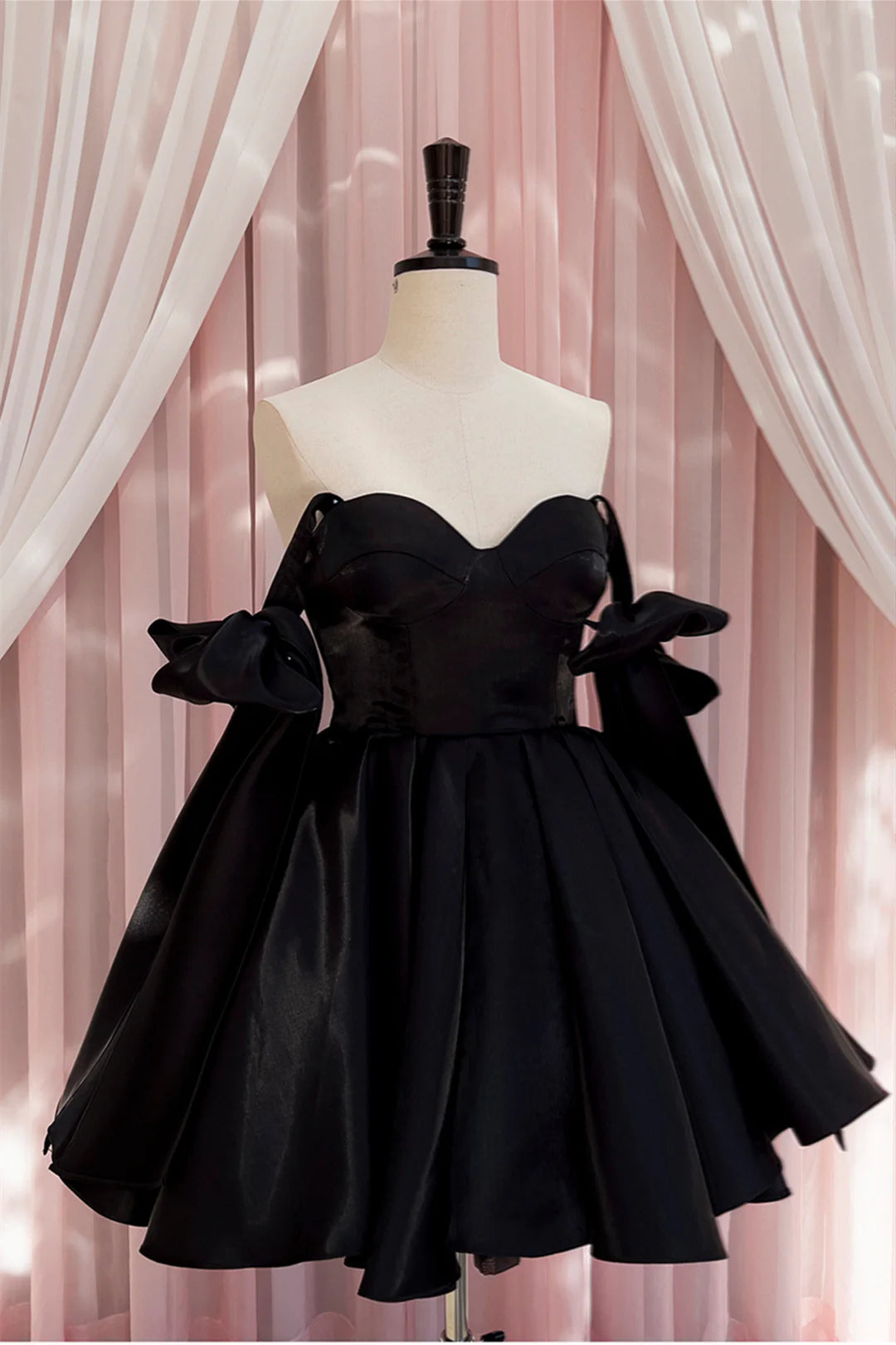 Back view of Koutun Black Bow Tie Pleated A-line Short Dress.