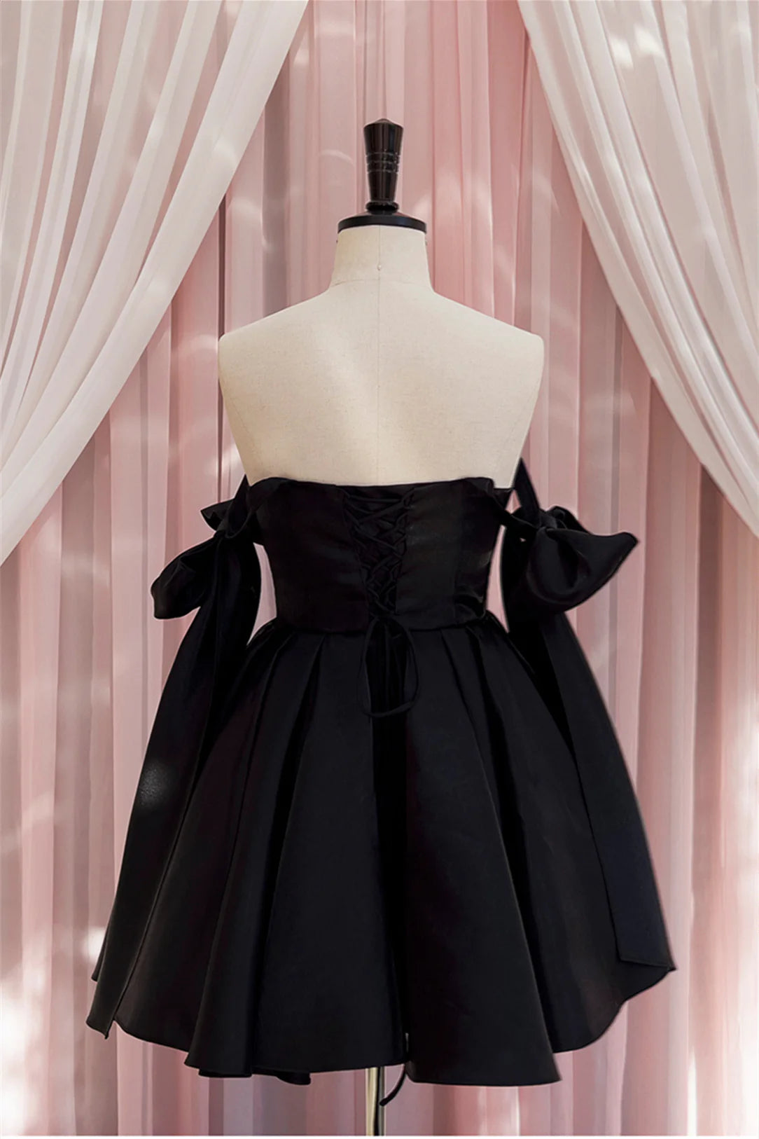 Close-up of bow tie detail on Koutun Black Dress.