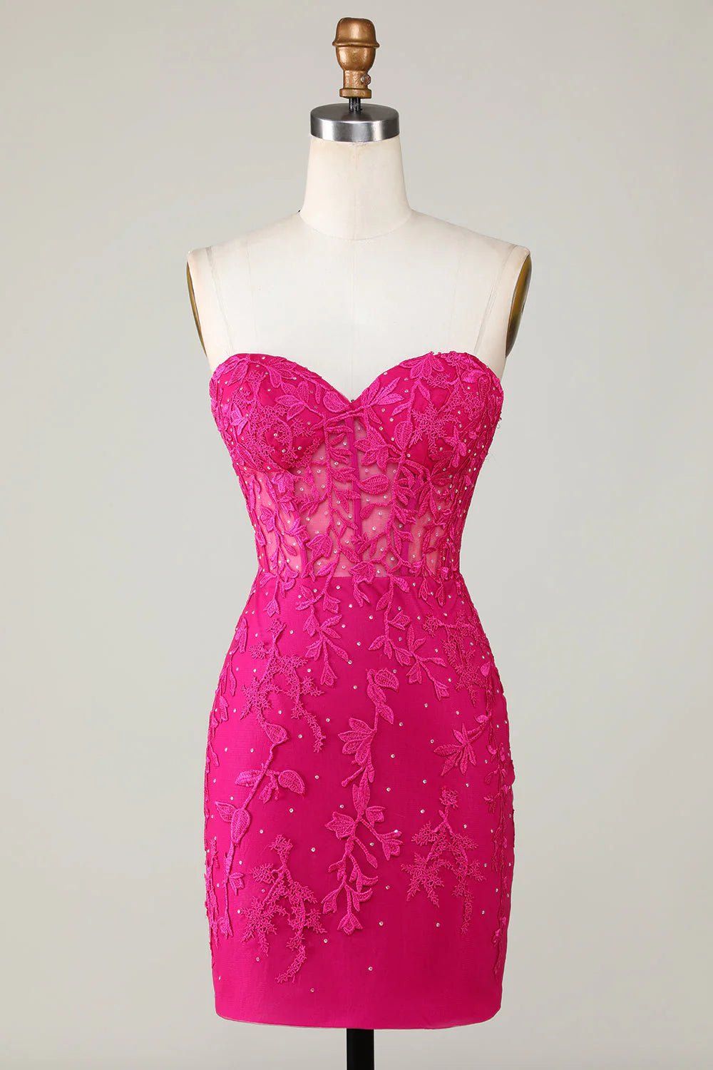 Back view of a bodycon sweetheart corset dress with appliques.