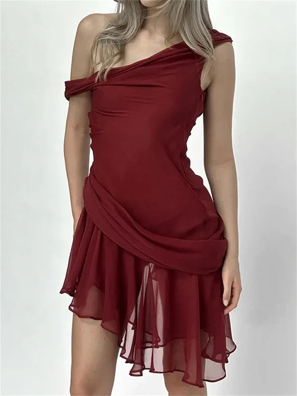 Close-up of ruffled and ruched details on a mini homecoming dress.