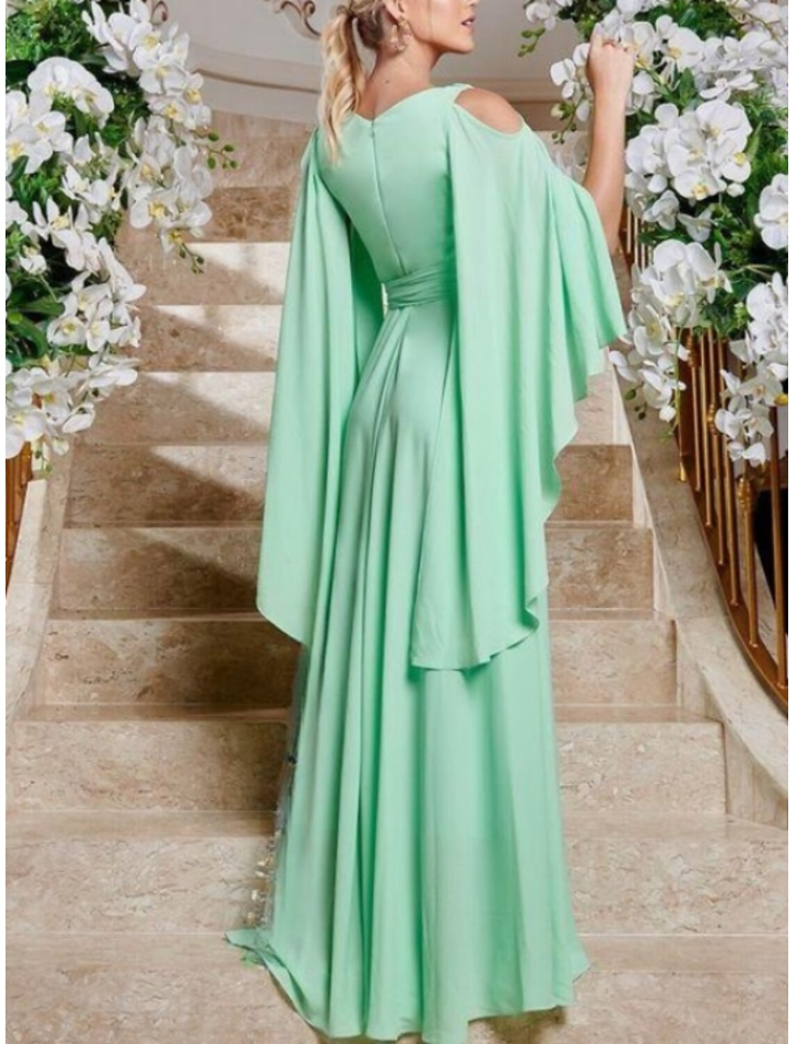 Back view of a floor-length chiffon column dress, showing the elegant drape and subtle details.