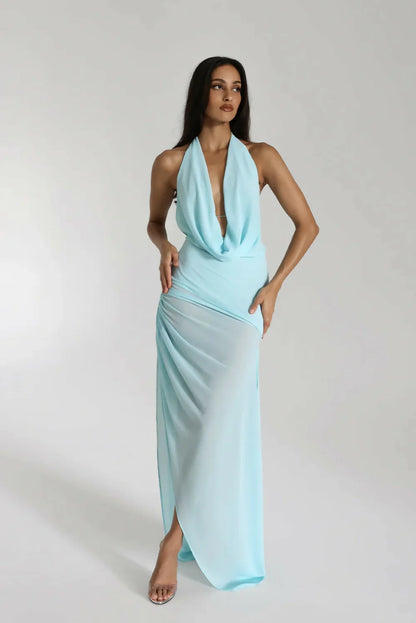 Woman posing in a short sleeveless party dress.