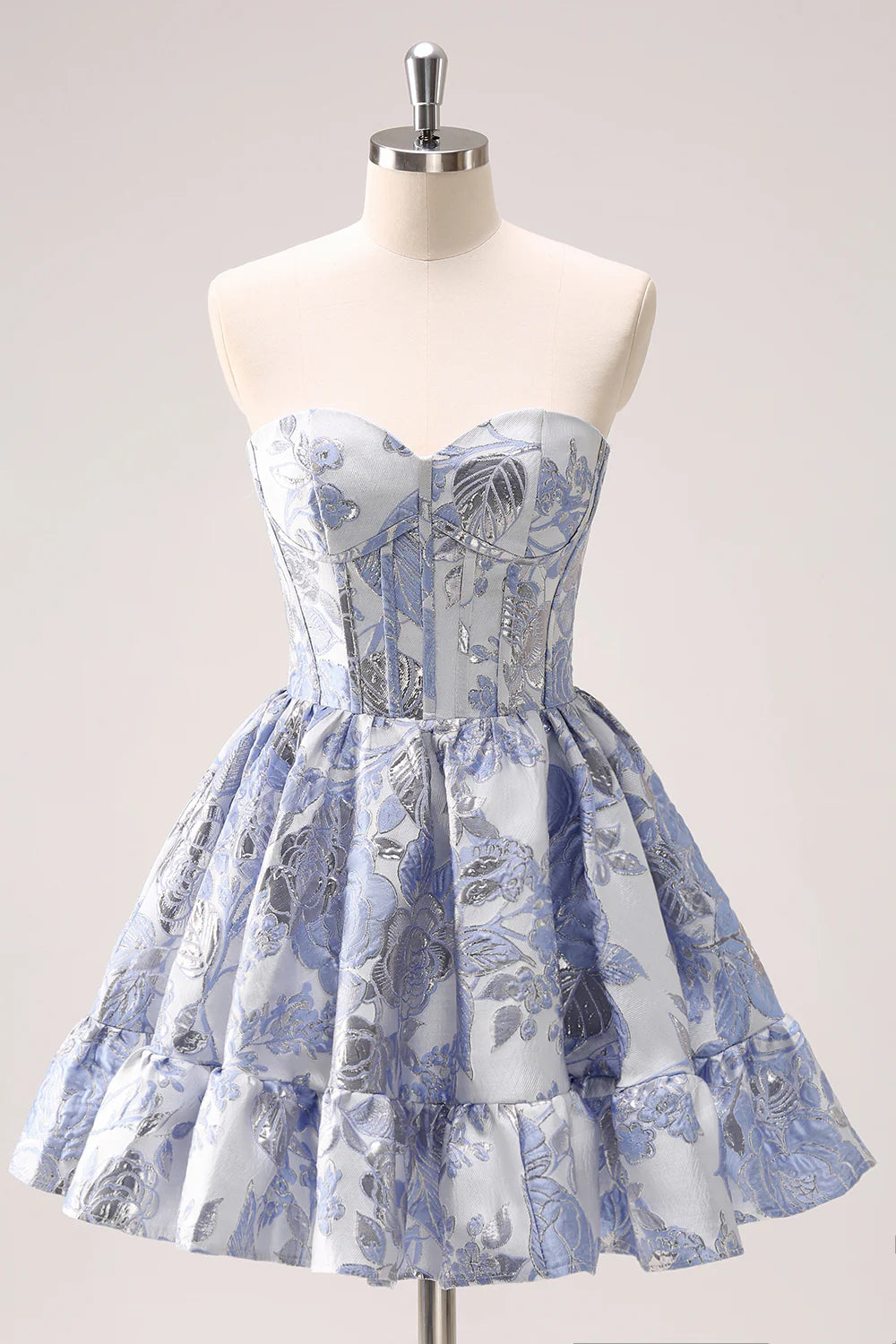 Model dancing in light blue floral strapless mini dress, showing movement.