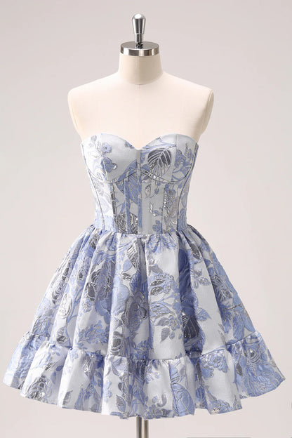 Model dancing in light blue floral strapless mini dress, showing movement.