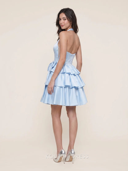 Back view of light blue tiered satin homecoming dress with bow detail.
