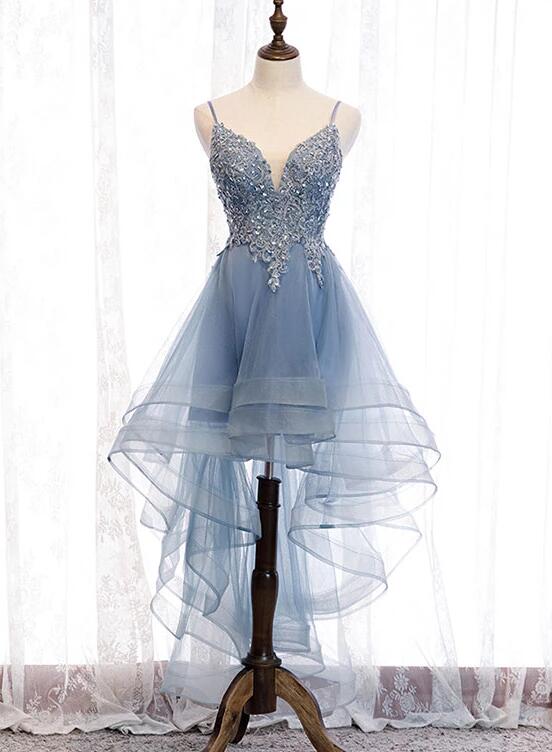 Model wearing a blue high-low tulle party dress with V-neck and lace details.