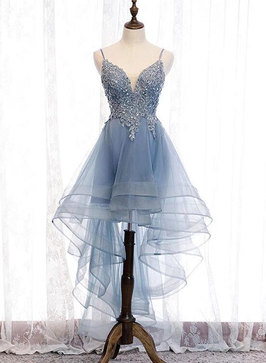 Model wearing a blue high-low tulle party dress with V-neck and lace details.