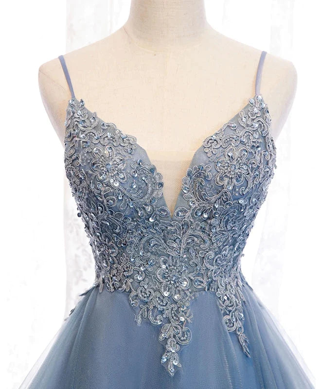 Side view of the blue high-low dress, highlighting the tulle fabric and hem.