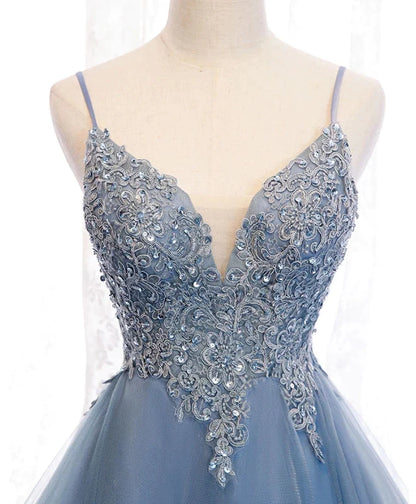 Side view of the blue high-low dress, highlighting the tulle fabric and hem.