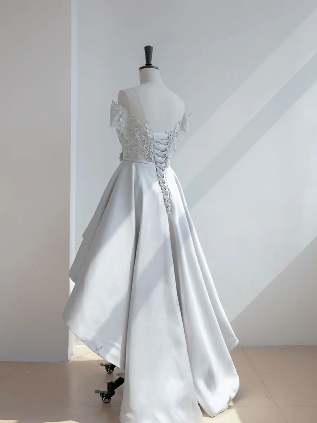 Back view of the high-low lace satin dress, showcasing the elegant train.
