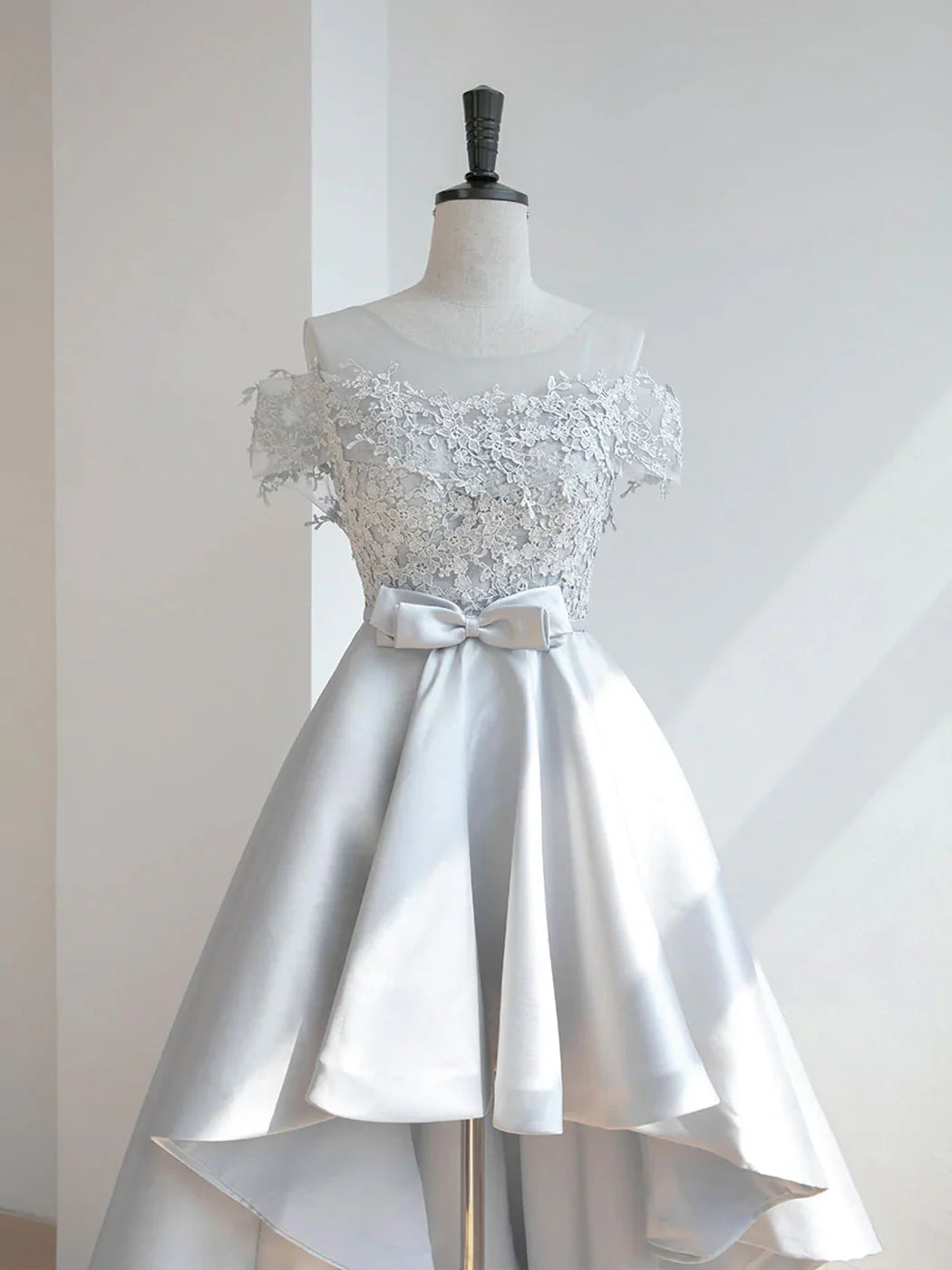 Side view of the high-low prom dress, highlighting the delicate lace details.