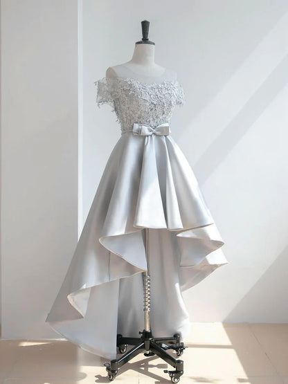 Close-up of the scoop neckline and lace bodice of the satin dress.
