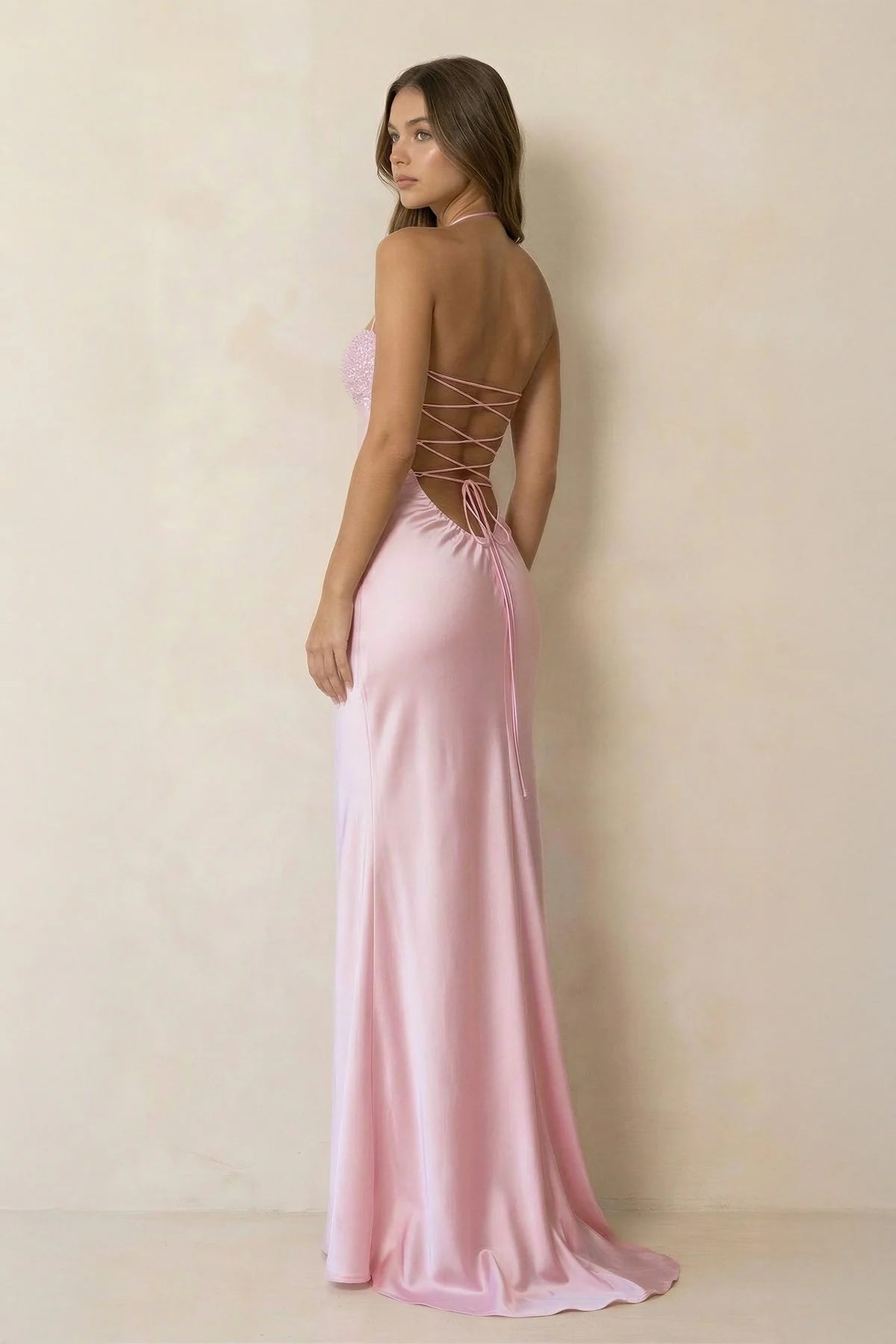 Close-up of the lace-up open back on a satin mermaid formal gown.