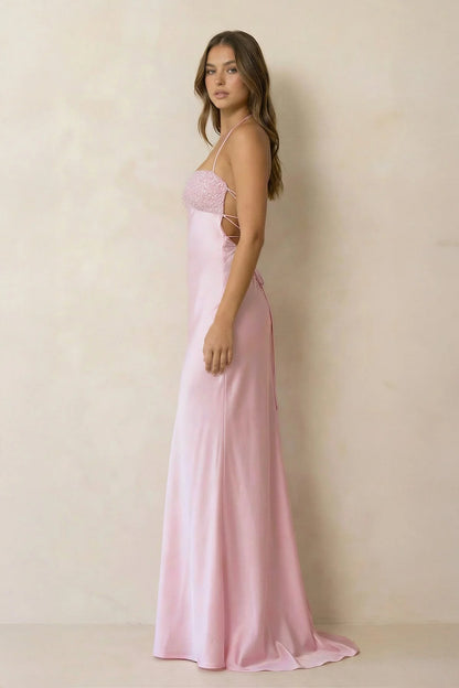 Side view of the floor-length satin mermaid dress with beaded halter neckline.