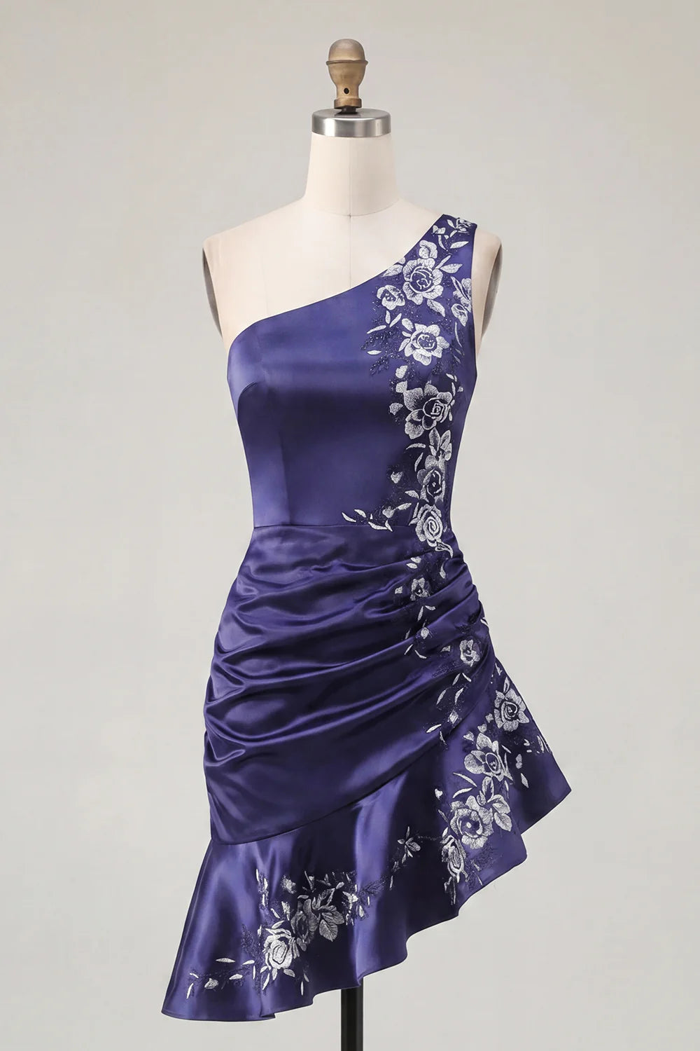 Back view of the navy blue one-shoulder dress, highlighting the asymmetrical hemline.
