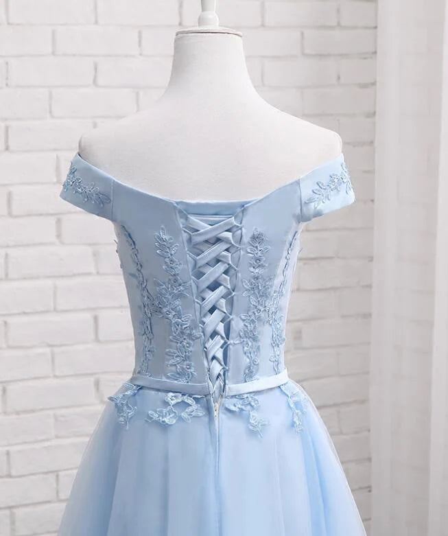 Model showcasing the back view of a short off-shoulder party dress.