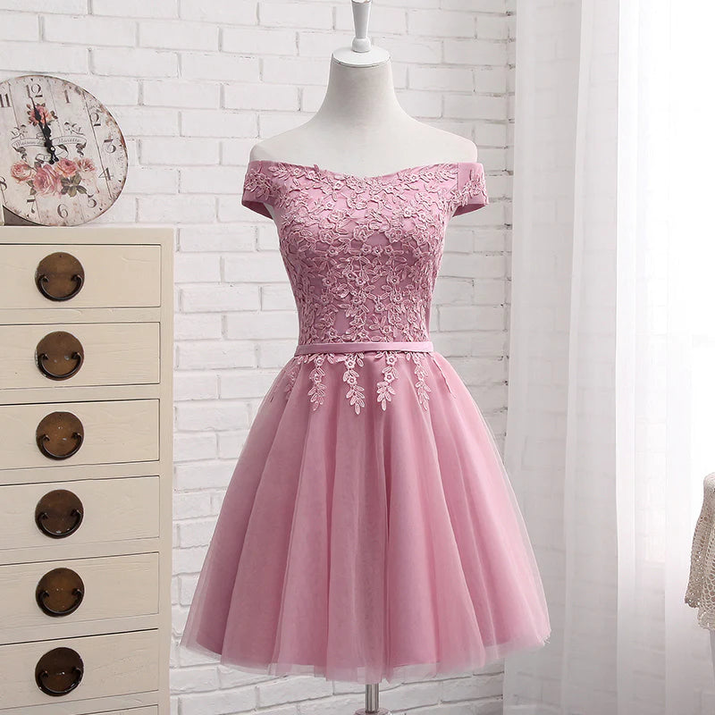 Close-up of the off-shoulder neckline and fabric detail of the dress.