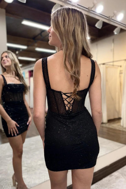 Model wearing Koutun off-shoulder black beaded short homecoming dress, side view.