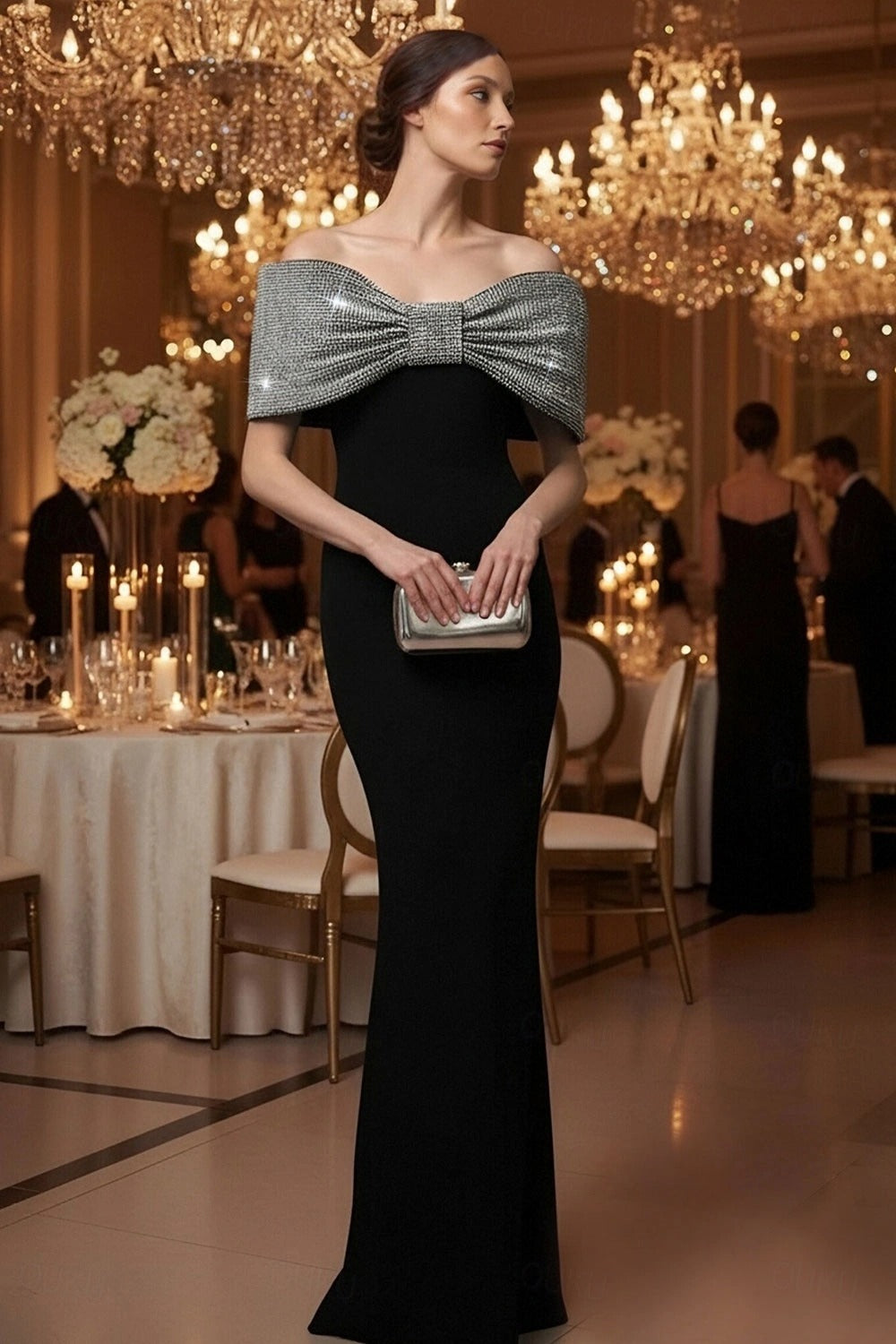 Model wearing Koutun black off-shoulder mermaid dress with beaded bow, front view.