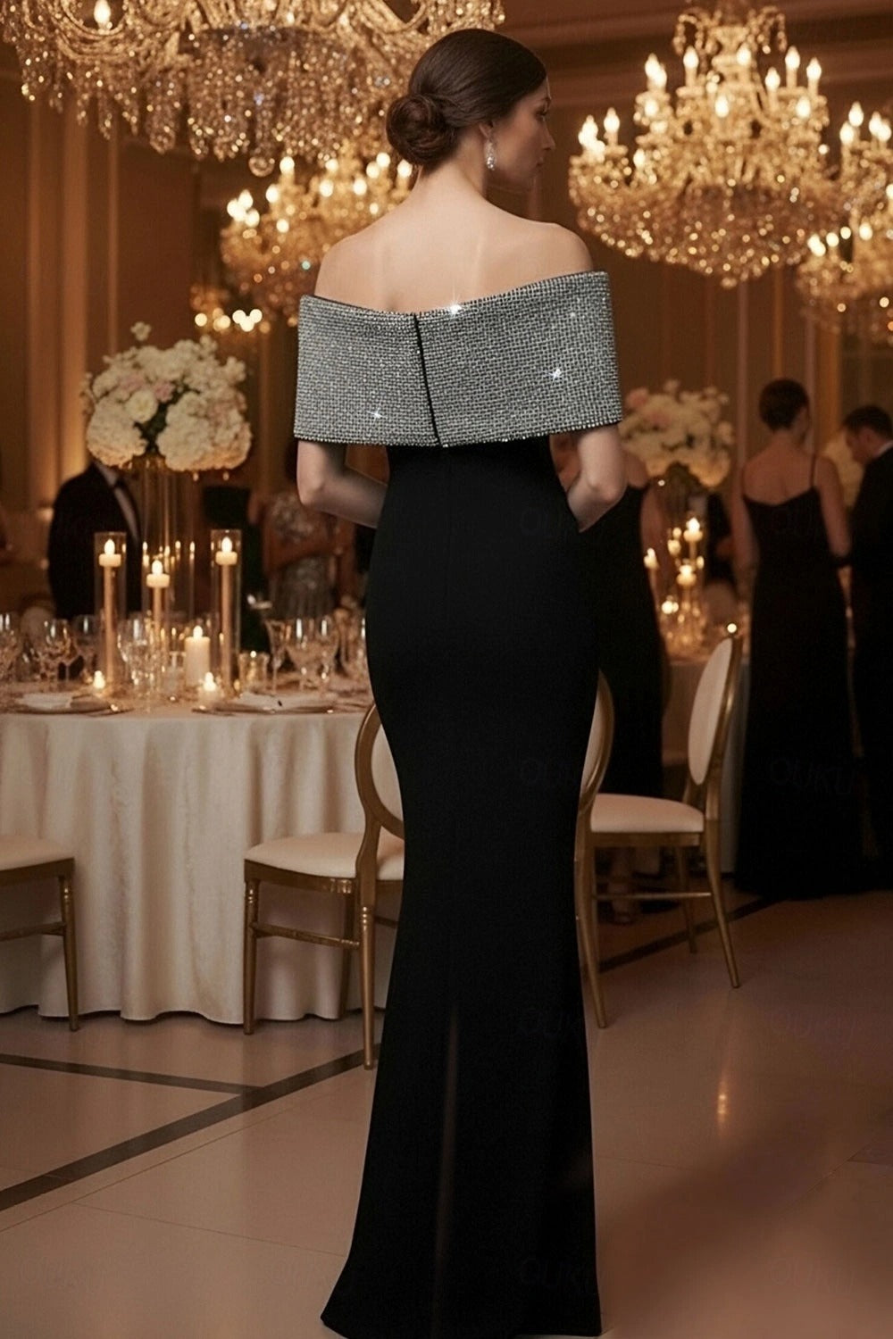 Side view of Koutun black off-shoulder mermaid dress with beaded bow.