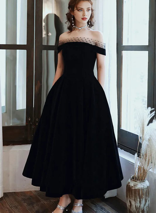 Model wearing an elegant off-shoulder black velvet floor-length dress.
